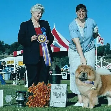 Amy and a Chow Chow with a Best in Specialty Show rosette